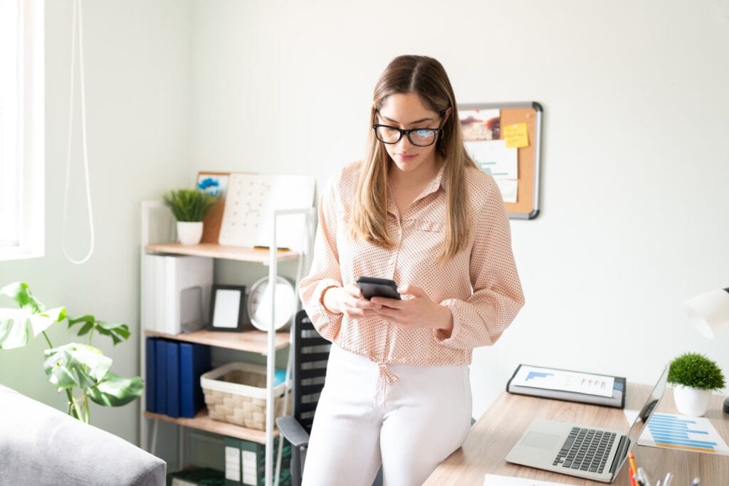 Female assistant checking texts on a phone